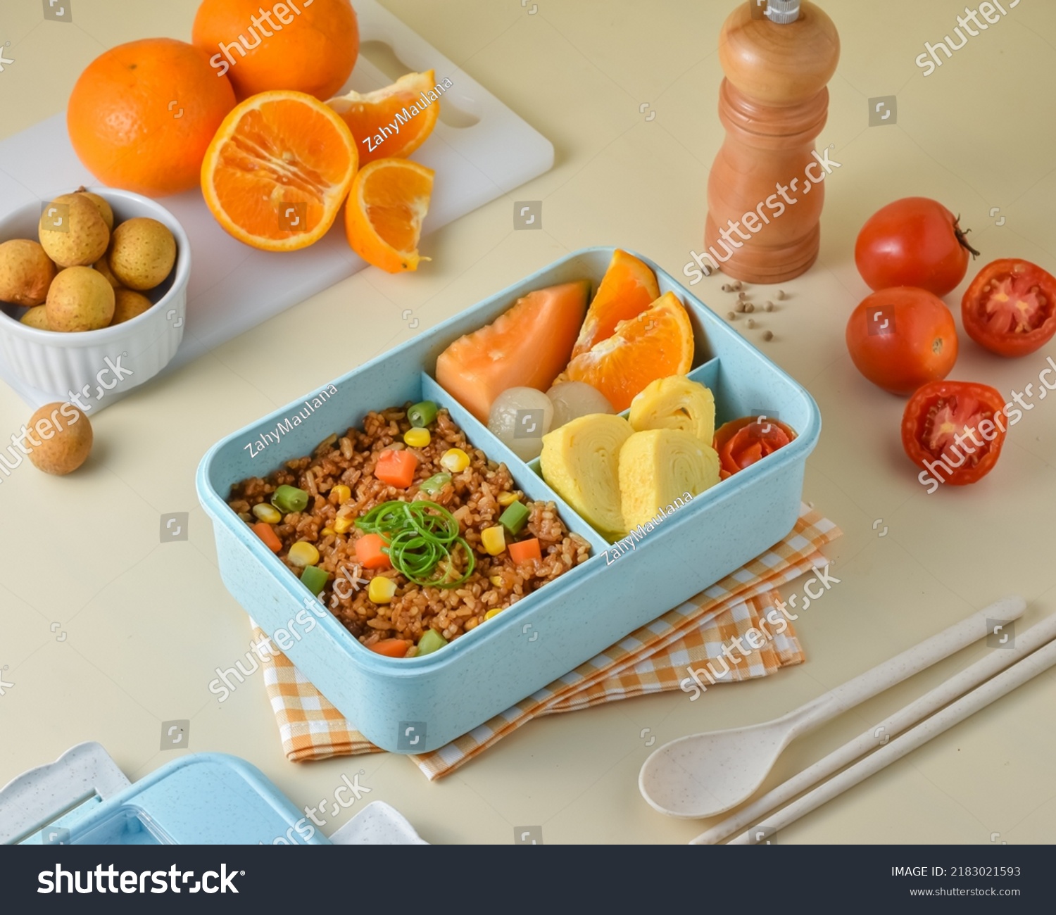 Prepare Children's School Supplies in the lunch box, with ingredients vegetables fried rice, tamagoyaki or omelet, orange, melon, and longan.  #2183021593