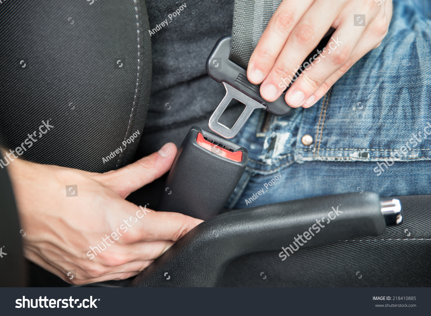 Closeup of man fastening seat belt in car #218410885