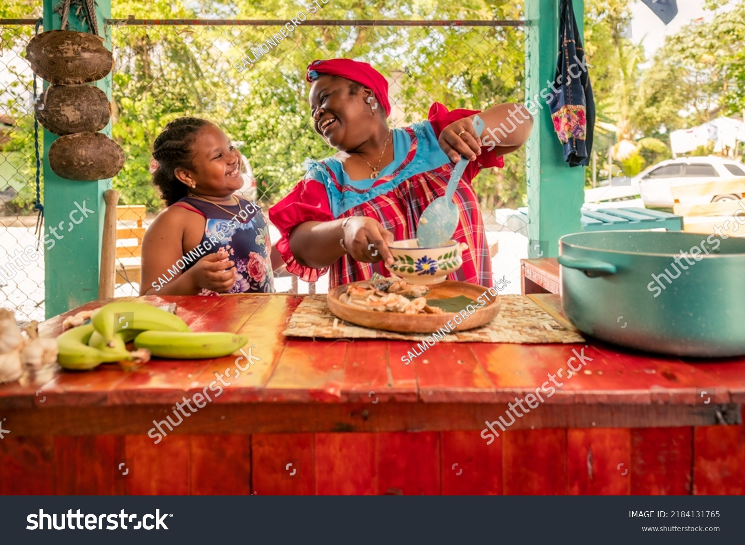African American mother and daughter or grandmother and granddaughter enjoy the moment of being together in the kitchen. Happy family in the kitchen. #2184131765