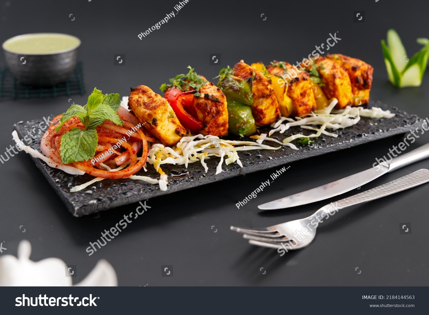 Paneer Tikka is popular Indian appetizer made with cubes of paneer and veggies marinated with yogurt and spices #2184144563