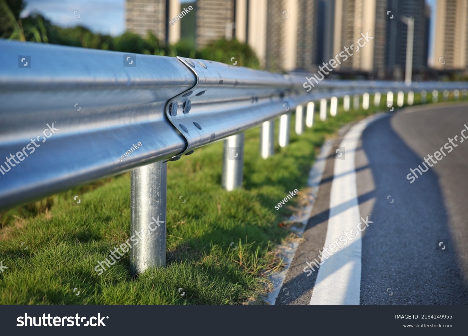 Traffic barrier on bridge highway road.  protect vehicles from accident.  guardrails.  Industrial city background. #2184249955