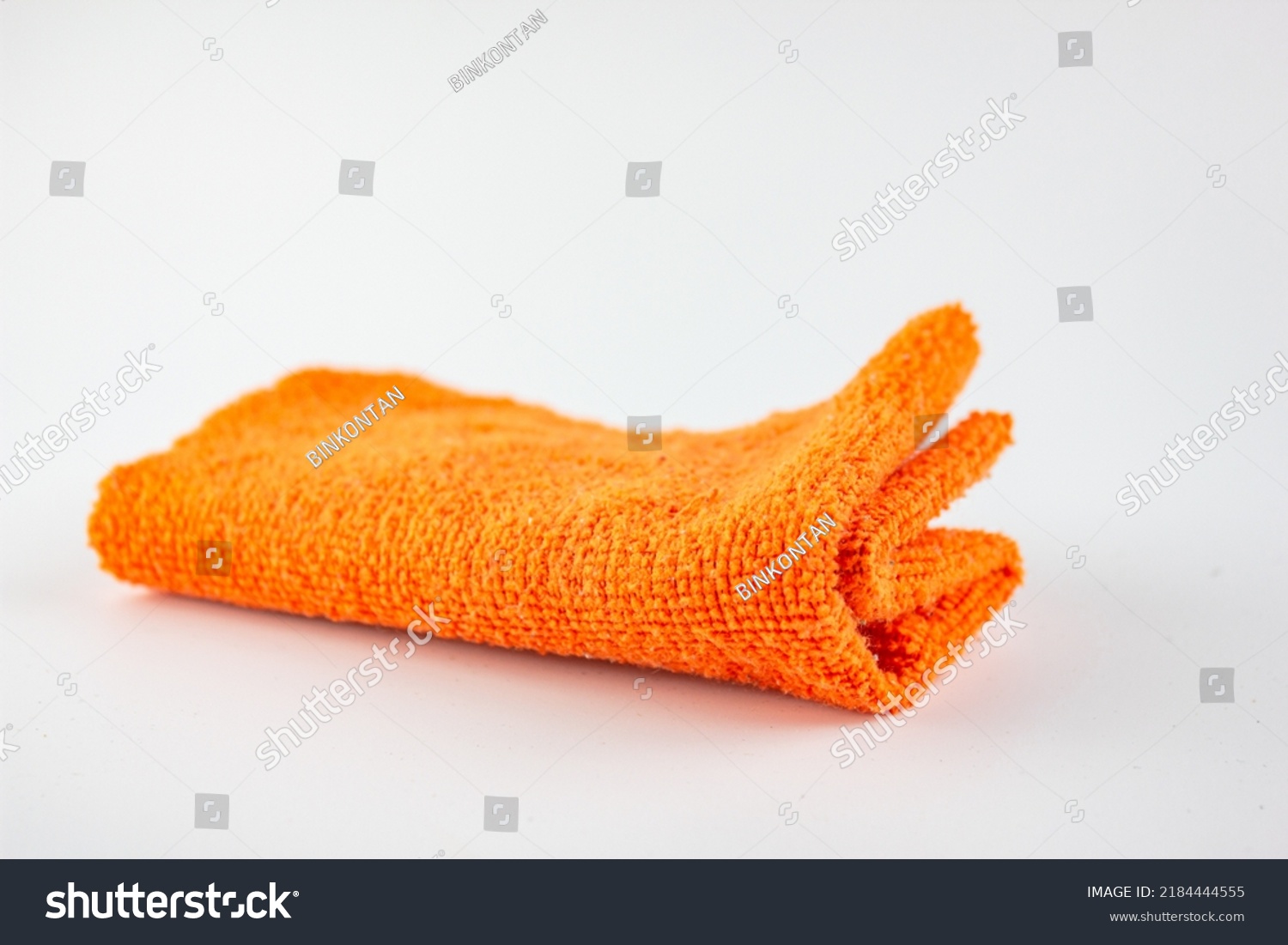 The Fiber cloth for cleaning. Rag for cleaning dust.Orange rag on a white background. #2184444555