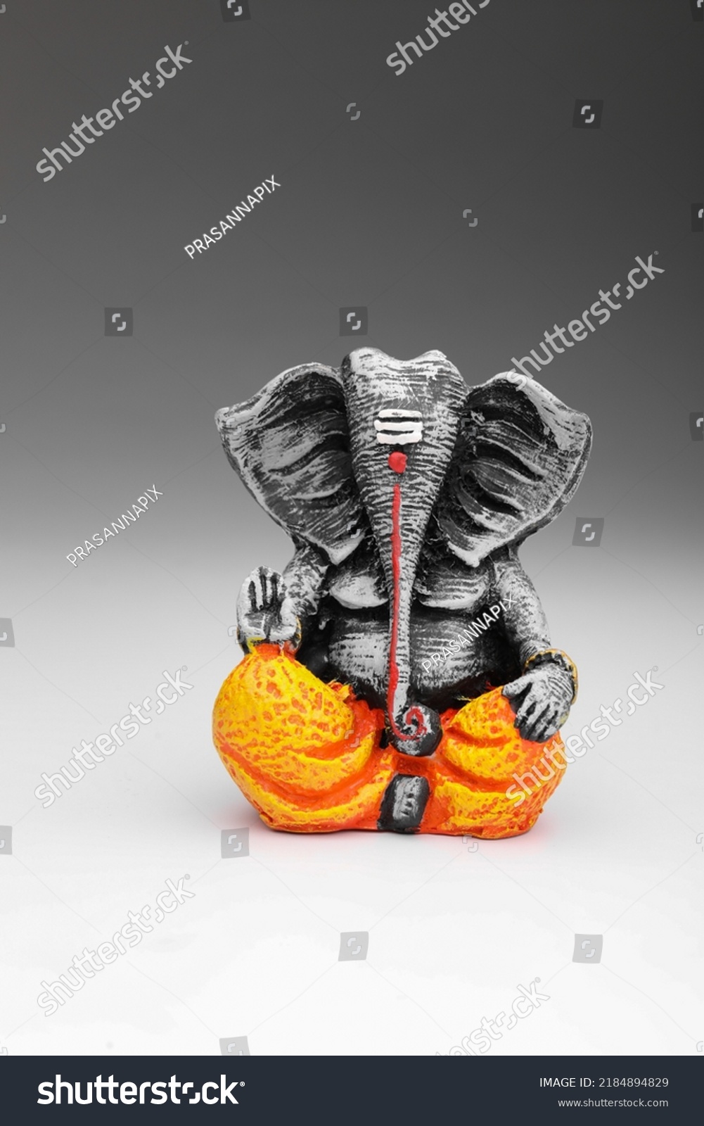 antique lord ganesha sculpture on white background. #2184894829