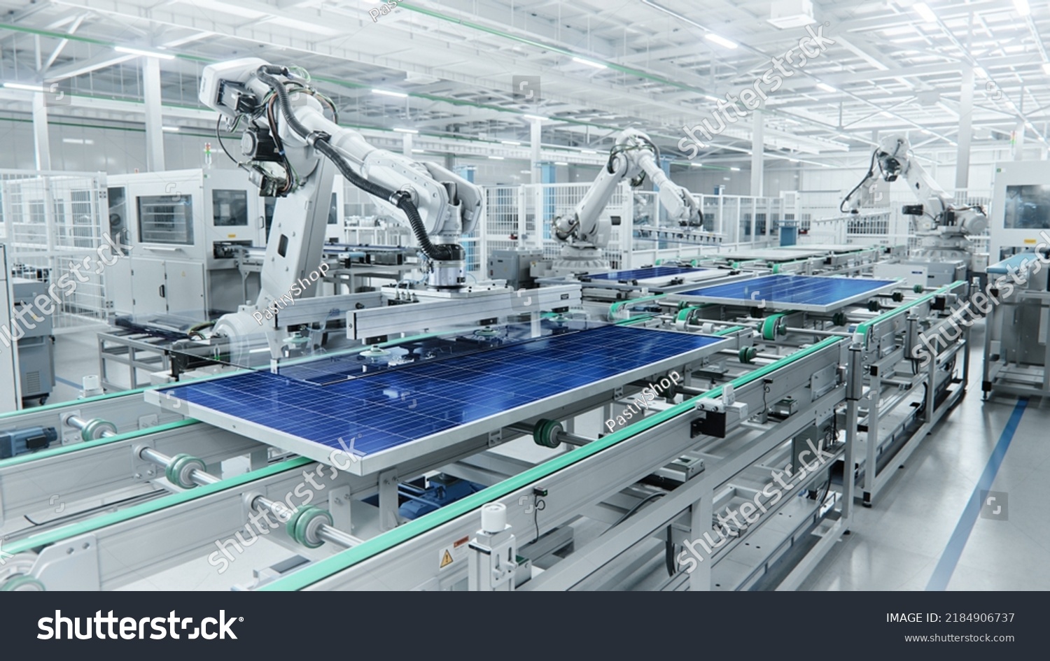 Wide Shot of Solar Panel Production Line with Robot Arms at Modern Bright Factory. Solar Panels are being Assembled on Conveyor. #2184906737