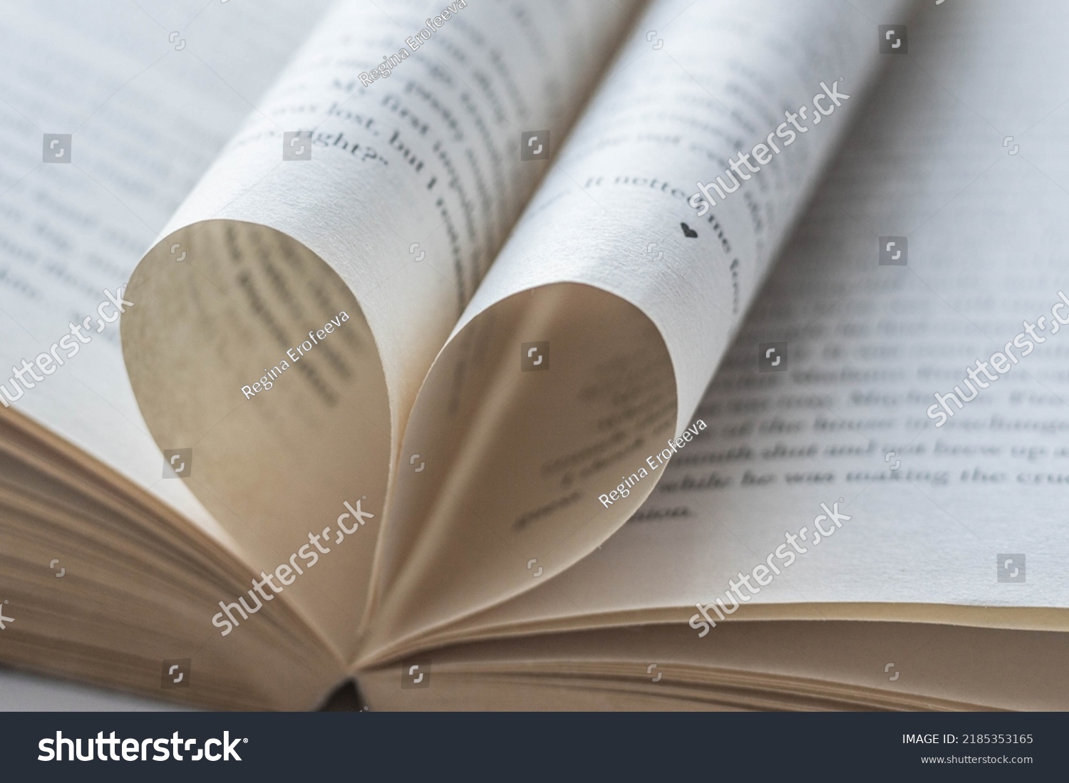 Love of books, reading. An open book with folded pages of books in the shape of a heart. Knowledge Day, Teacher's Day. Library. Reading books. #2185353165