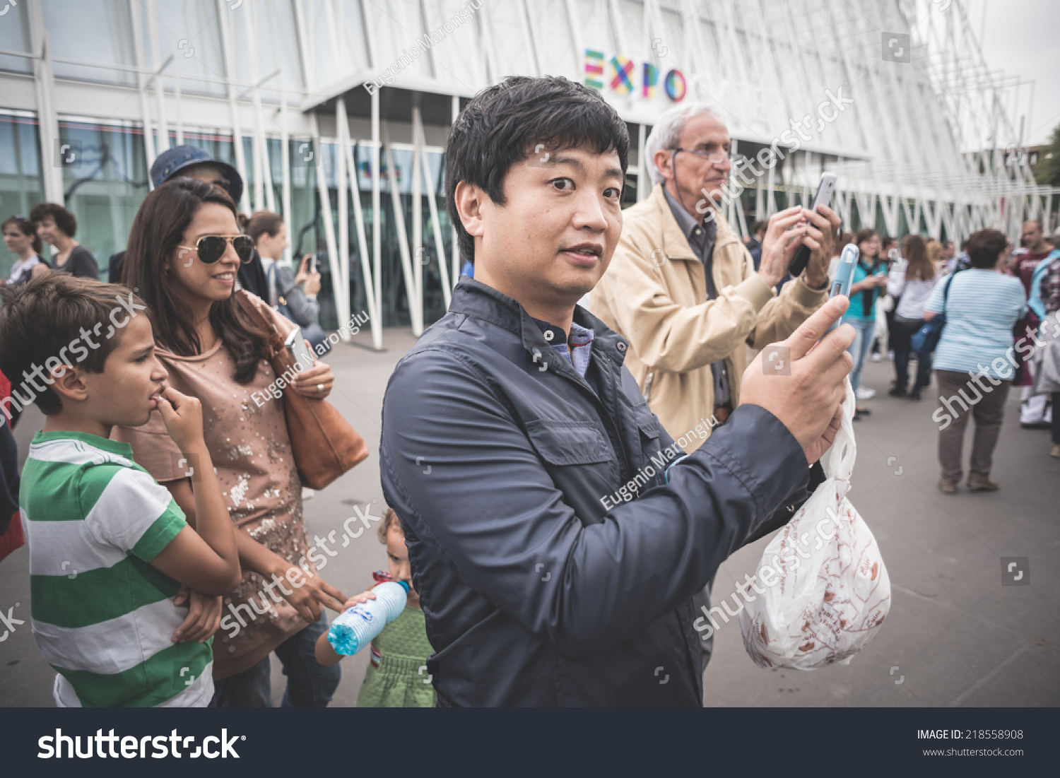 MILAN, ITALY - SEPTEMBER 20: People during Milan Fashion week in Milan, Italy on September, 20 2014. Eccentric and fashionable people in the city during fashion week wait for models and famous people #218558908