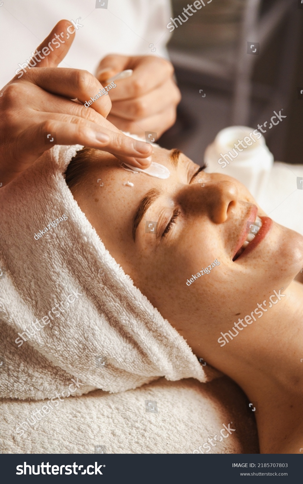 Close-up portrait of woman getting spa facial massage treatment with moisturising cream at beauty spa salon. Natural skin care cosmetic. Health care, beauty #2185707803