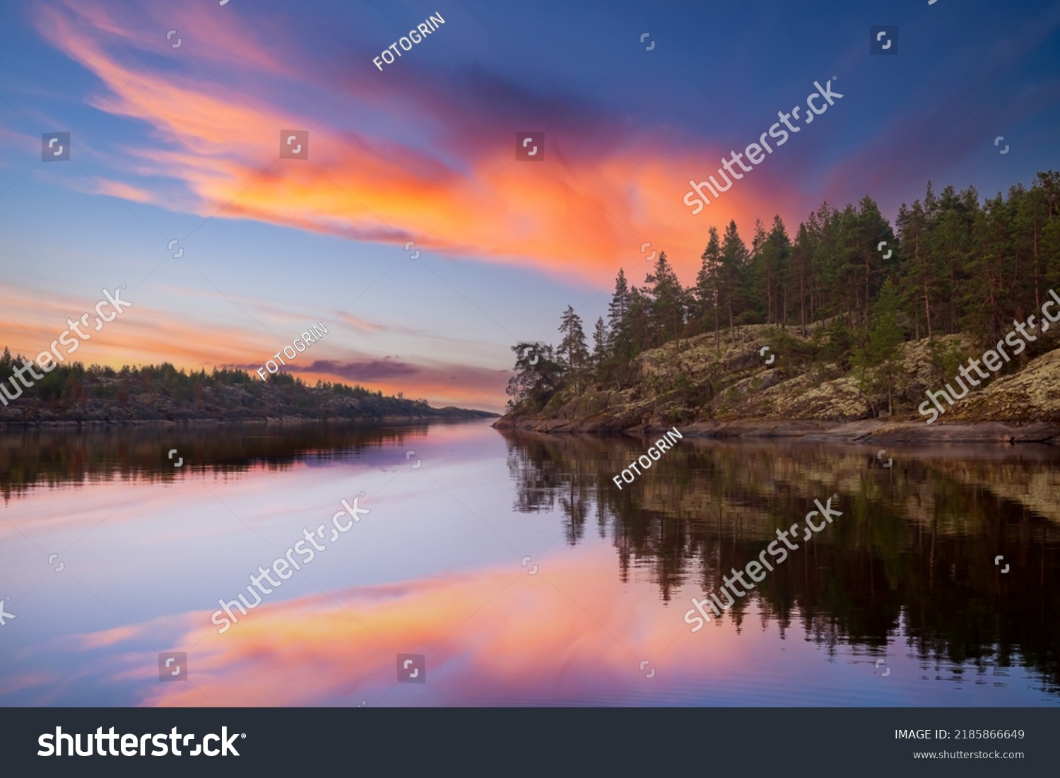 Karelian landscapes. Ladoga lake. Regions Russia. Pine trees on shore Lake Ladoga. Sunset in wild. Rocky coast Karelian lakes. Pine forest is reflected in water. Karelian Republic. Russian Federation #2185866649