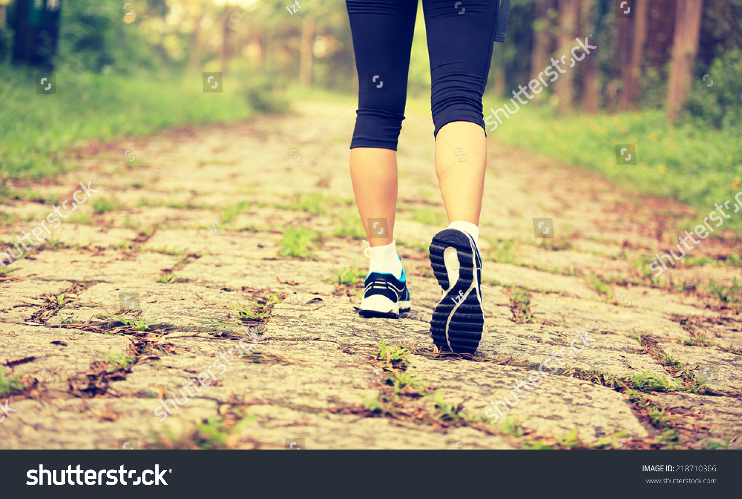 hiking woman legs walking on forest trail  #218710366
