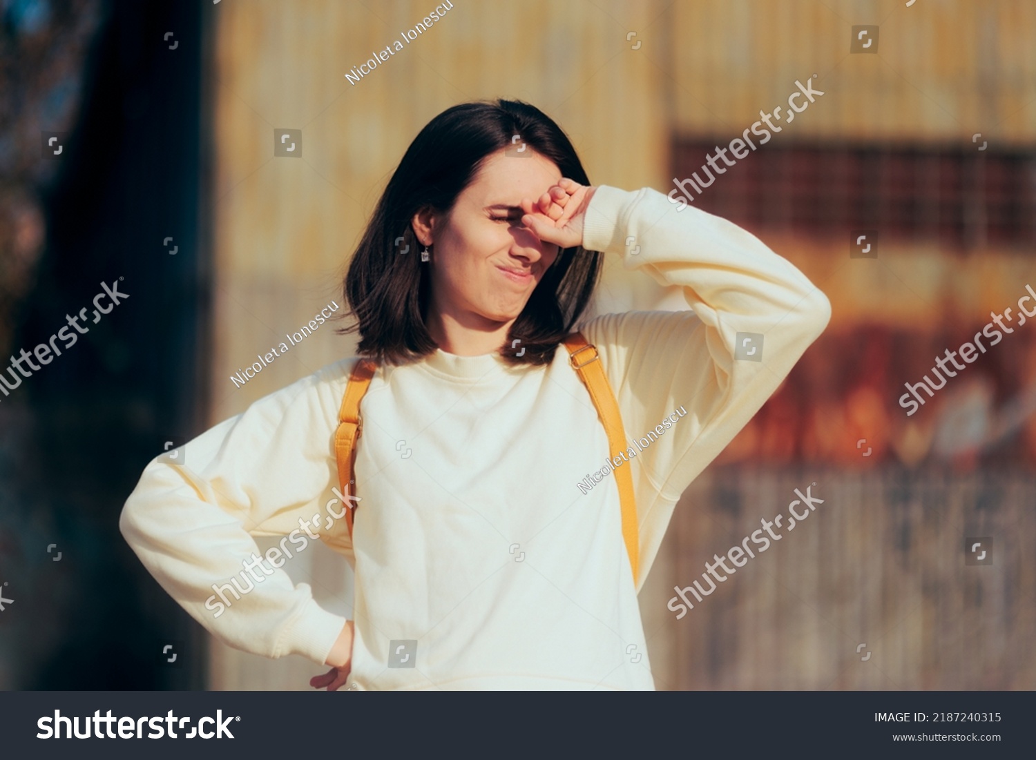 
Woman Covering Her Eyes from Strong Sun Shining in her Face. Unhealthy sunlight exposure for vision due to UV rays
 #2187240315