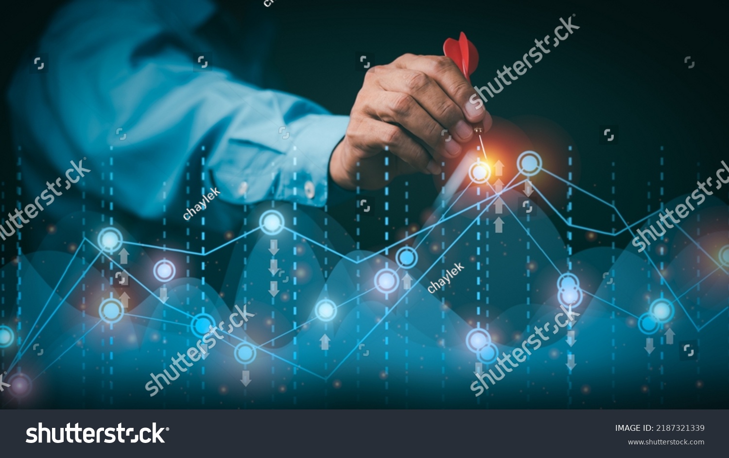 Businessman holding arrow pointing to graph, goal setting ideas and business strategies. through planning and teamwork To analyze and develop company performance from growth data to the future. #2187321339