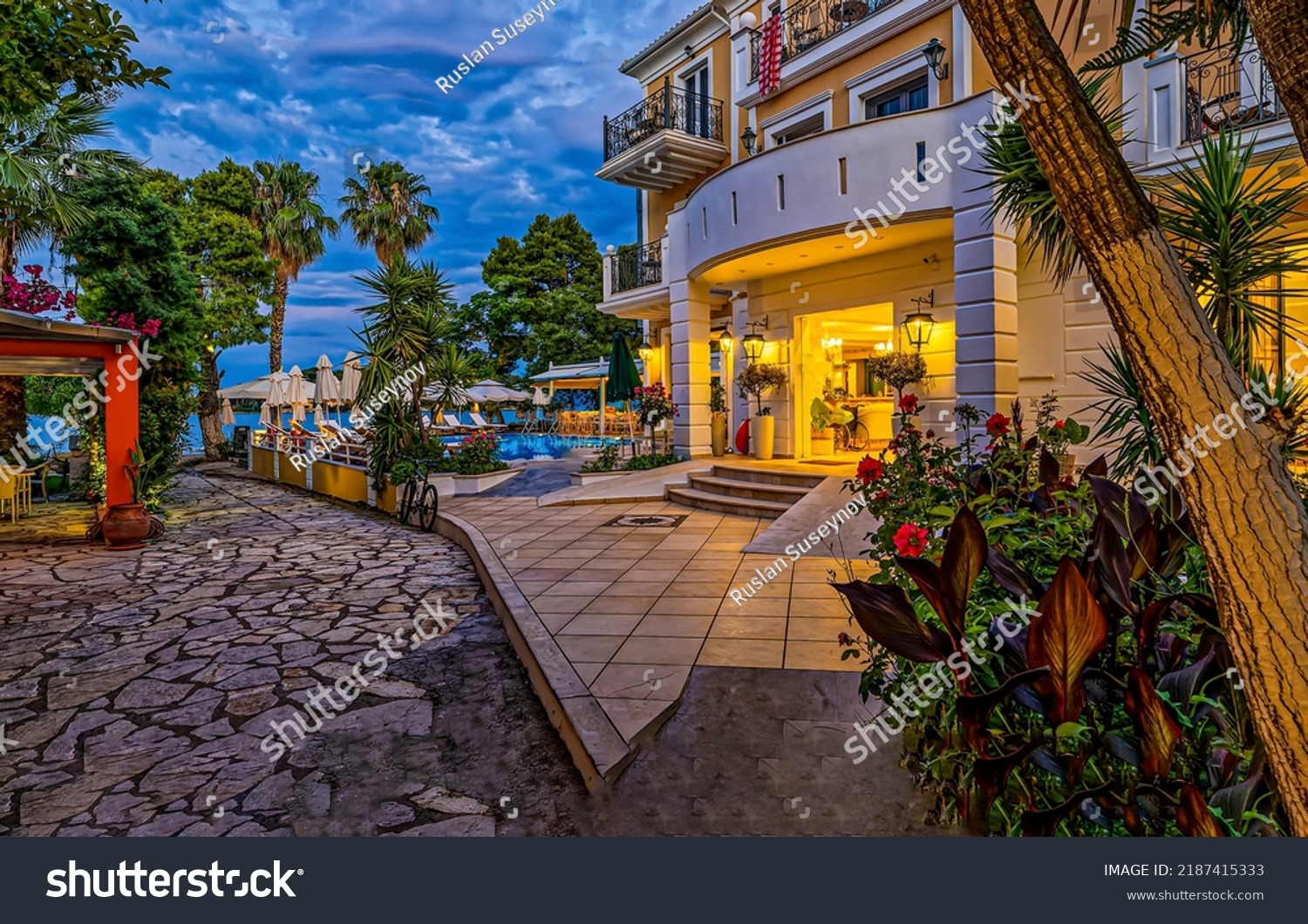Entrance to the resort hotel by the sea in the evening. Resort hotel building on vacation #2187415333