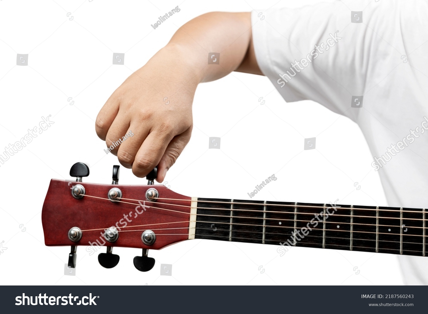 Man tuning guitar string isolated over white background #2187560243