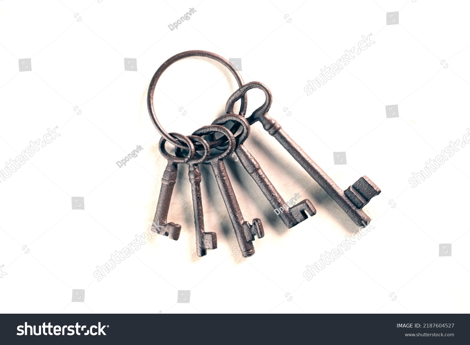 rusty bunch of old keys on white background, close up #2187604527