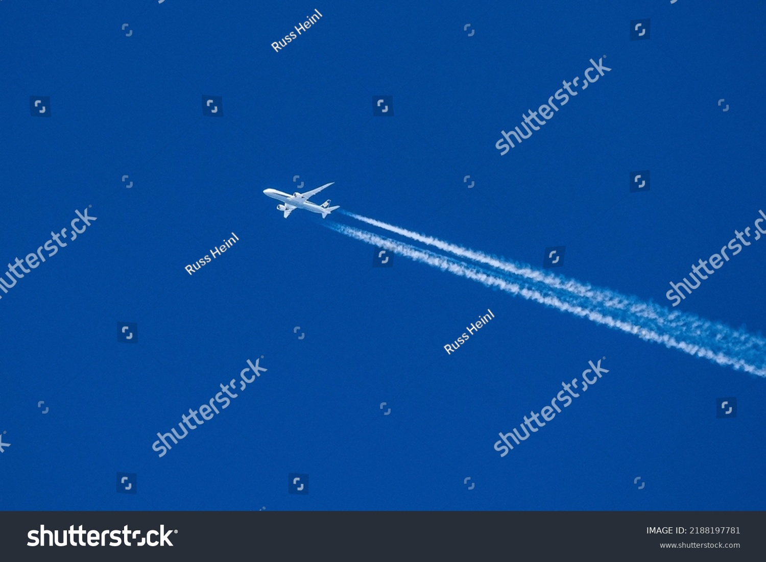 Sharp telephoto close-up of jet plane aircraft with contrails cruising from Tokyo to Chicago, altitude AGL 39,000 feet, ground speed 556 knots. #2188197781