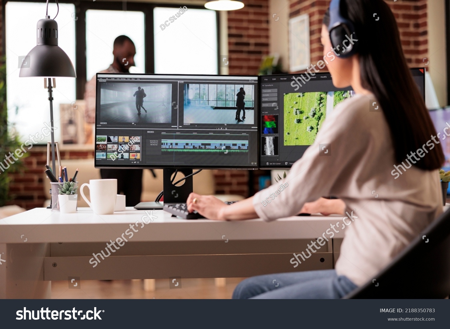 Creative digital editor editing movie footage at home, using professional effects software. Content creator working on multimedia montage with app and audio, post production film. #2188350783