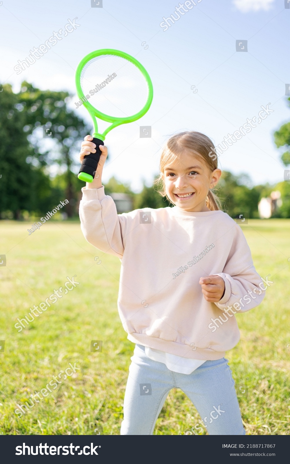 child holding badminton racket in the park, vacation, sport concept. #2188717867