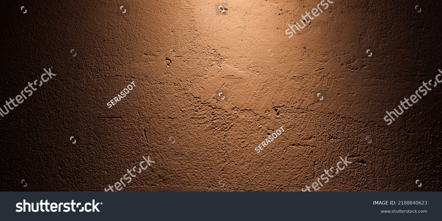 The rough-textured concrete patterned background on maroon wall provide a backdrop of bright light and shadow dark #2188840623