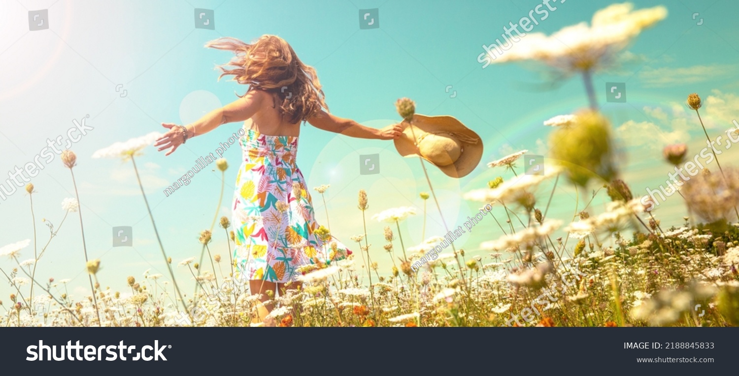 woman in a field with flowers- freedom,  active,  happiness concept #2188845833