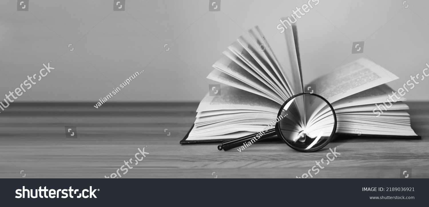 Book and magnifying glass banner with background for text. High quality photo #2189036921