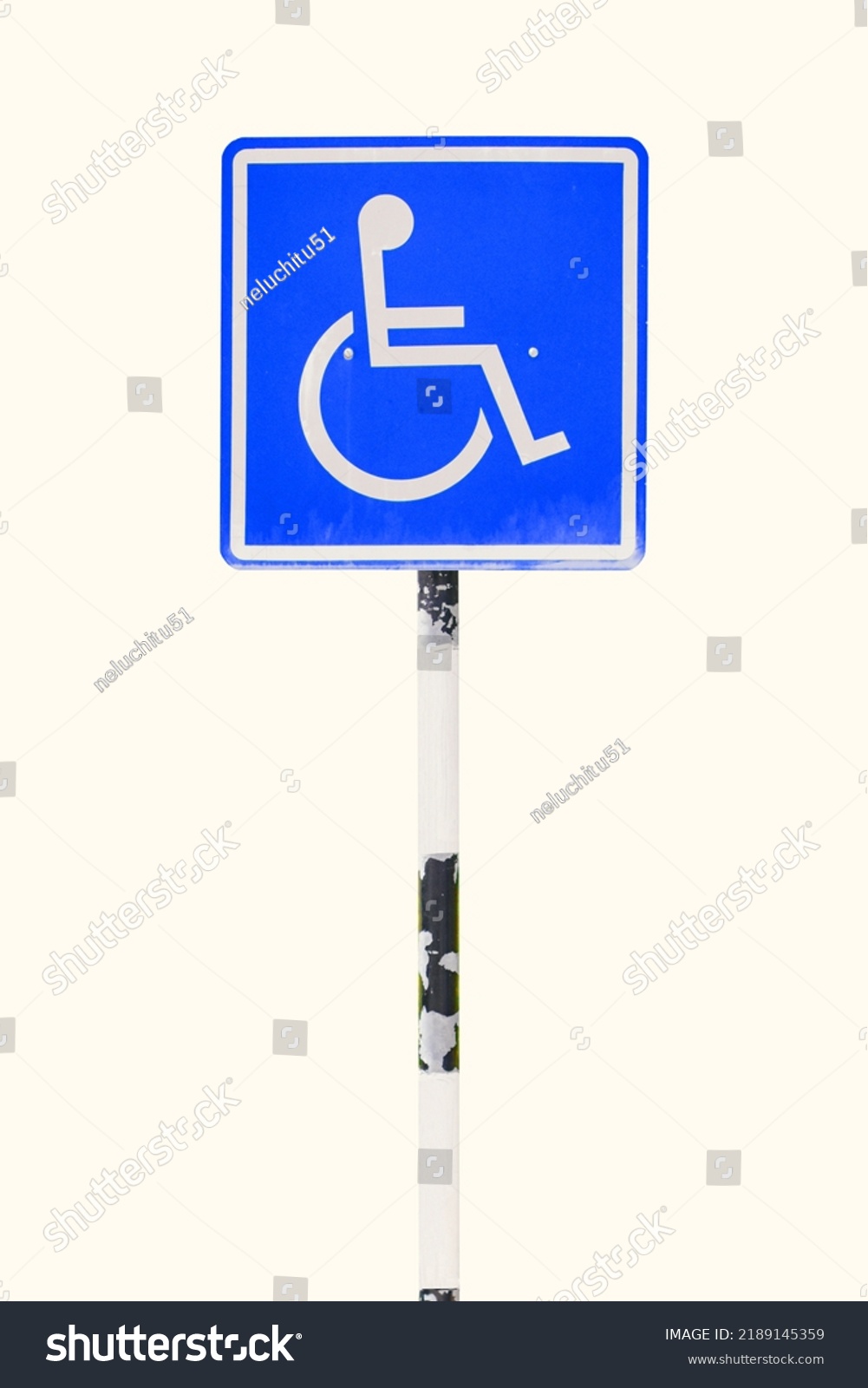 Blue handicapped sign parking spot. Disabled parking permit sign on pole isolated on white background. Object with clipping path #2189145359
