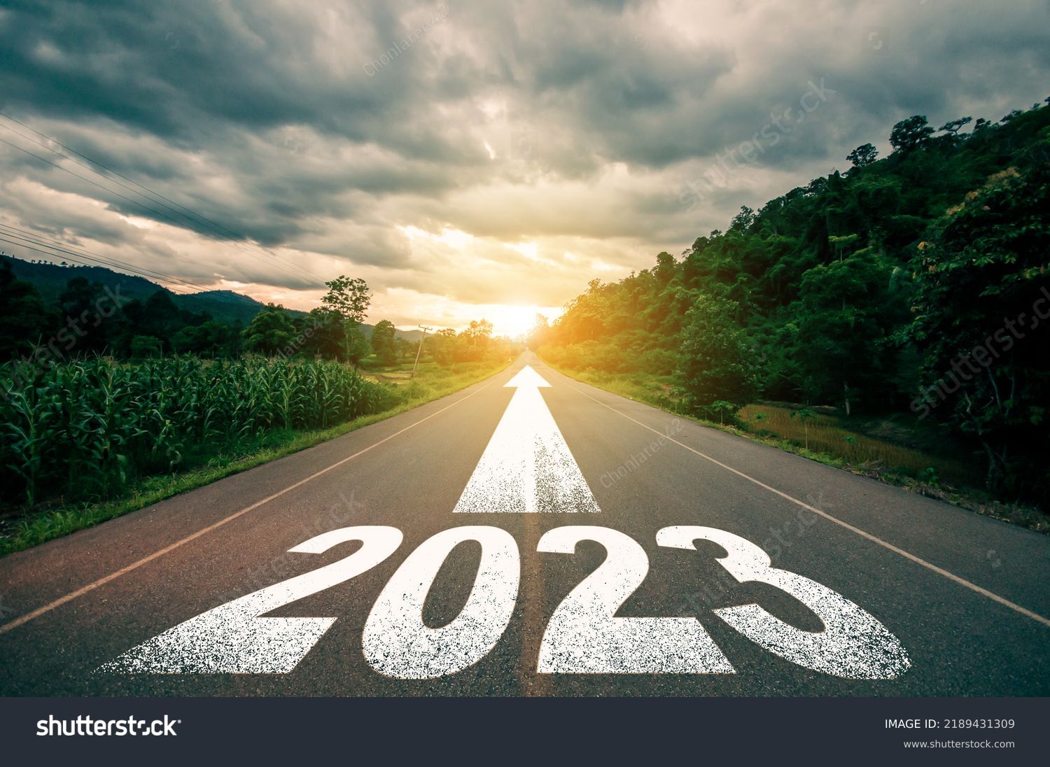 New year 2023 or straight forward concept. Text 2023 written on the road in the middle of asphalt road with at sunset. Concept of planning, goal, challenge, new year resolution.
 #2189431309