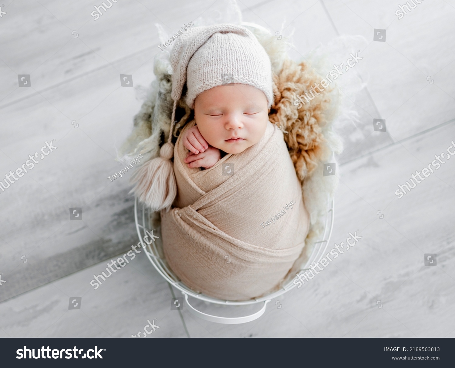 Newborn baby child swaddled in fabric sleeping in basket. Sweet infant kid napping portrait #2189503813