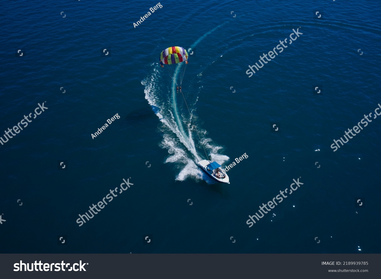 Drag Boat parasailing top view. The boat pulls a parachute with people. #2189939785