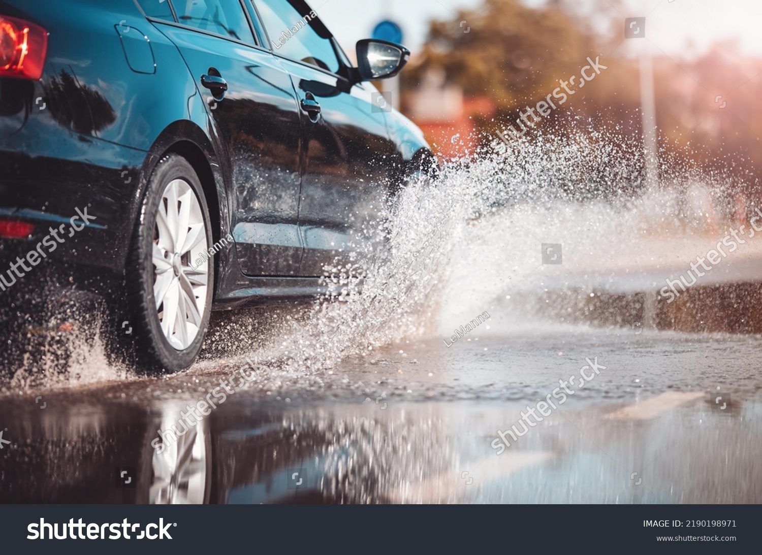 Car driving through the puddle and splashing by water. #2190198971