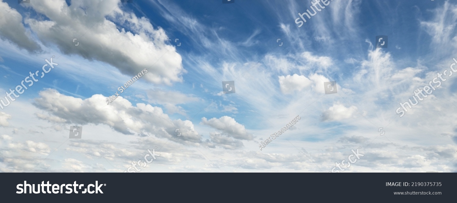 Ornamental clouds. Dramatic sky. Epic storm cloudscape. Soft sunlight. Panoramic image, texture, background, graphic resources, design, copy space. Meteorology, heaven, hope, peace concept #2190375735