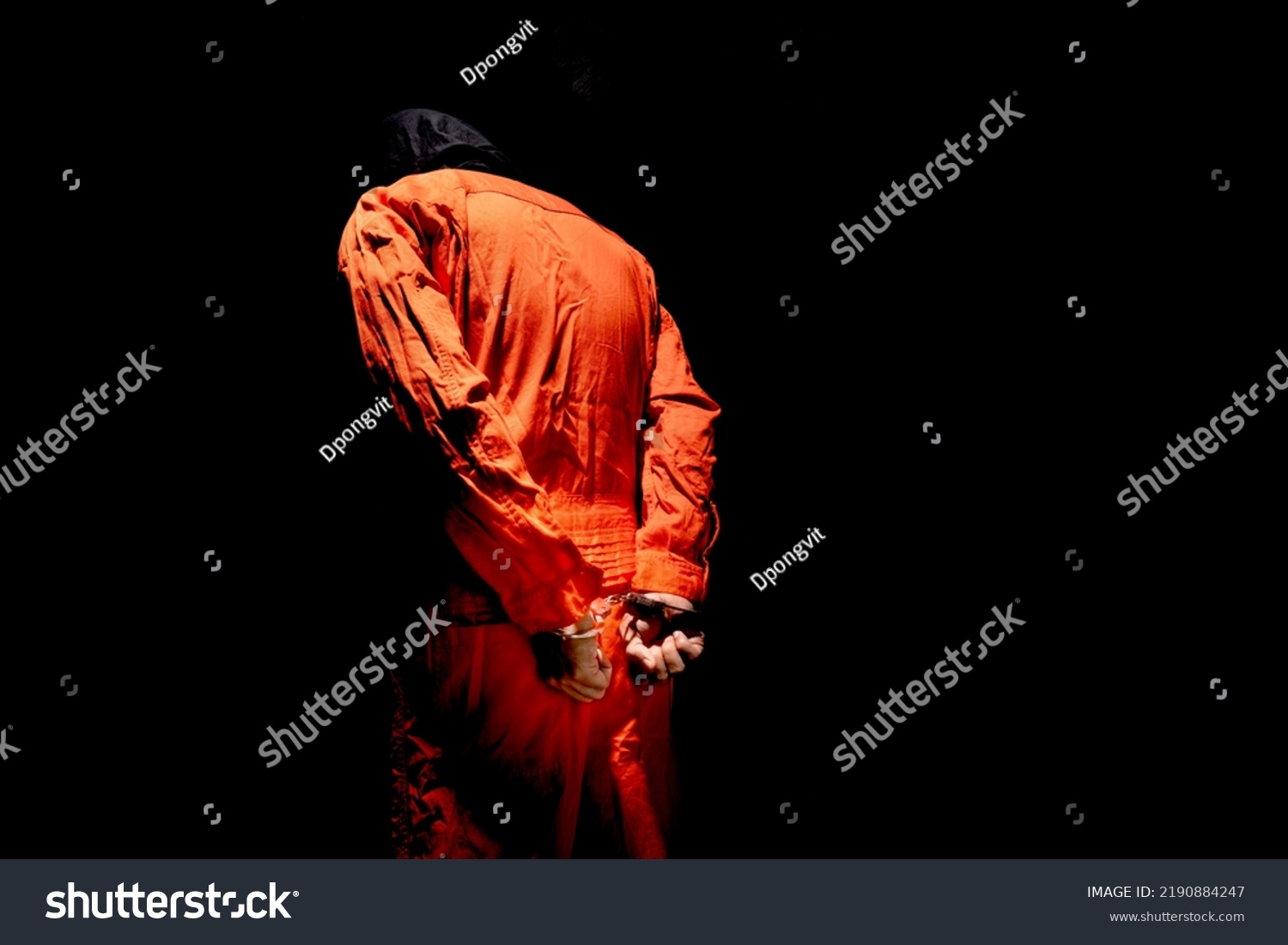 Handcuffs on Accused Criminal in Orange Jail Jumpsuit. Law Offender Sentenced to Serve Jail Time, in black background
 #2190884247