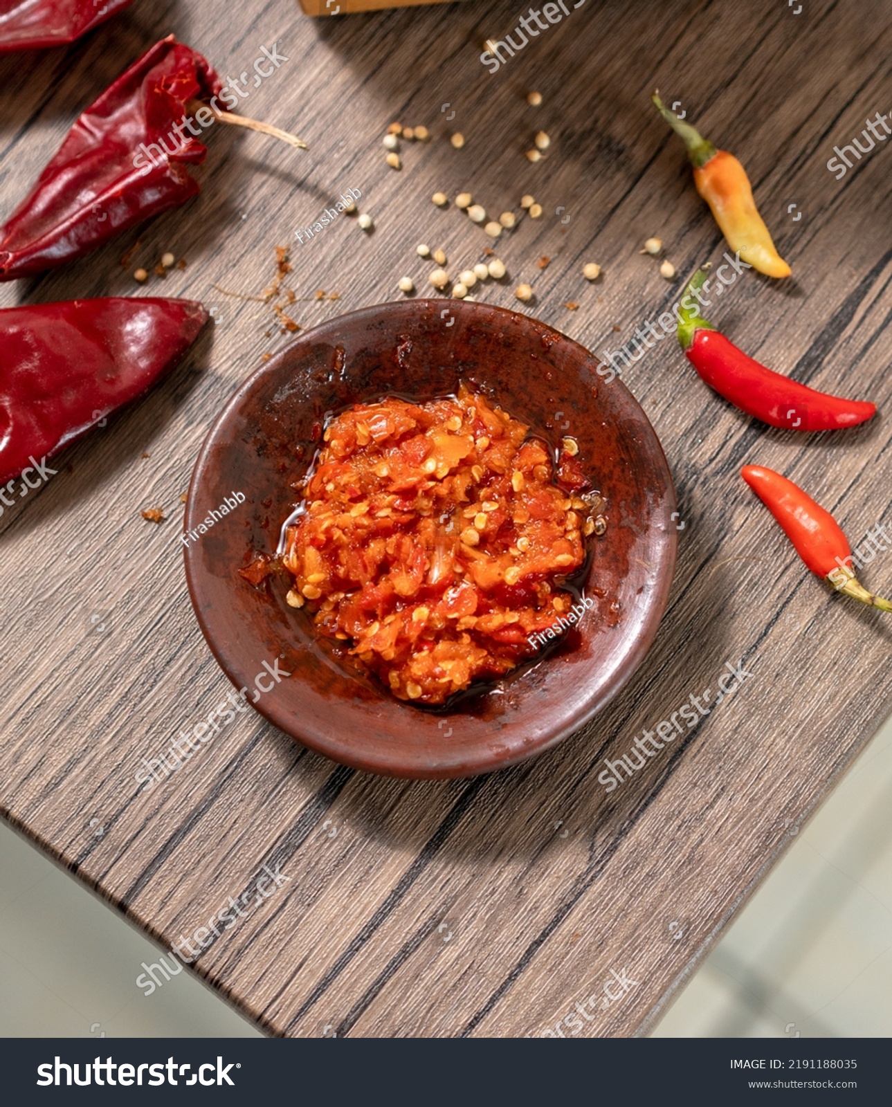 Traditional Indonesian Chili Sauce or Sambal Uleg. Made from Chili, Onion, Garlic, Tomato and Palm Oil. It's Made Using Uleg or Food Smasher from Claypot.  #2191188035