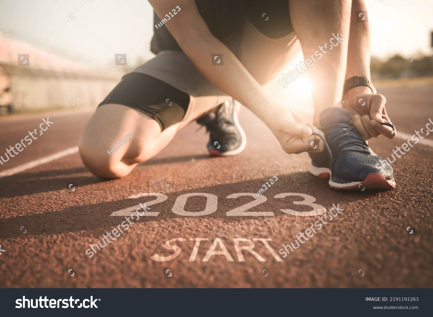 happy new year 2023,2023 symbolises the start into the new year.Start of people running on street,with sunset light.Goal of Success #2191191263