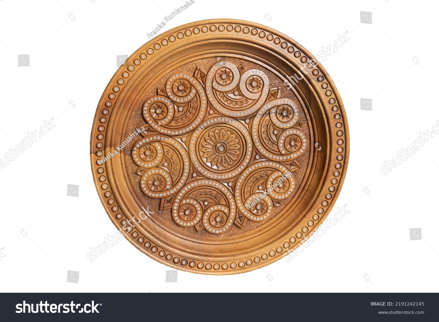Isolated on white wooden souvenir plate with carved and decorated ornament #2191242145