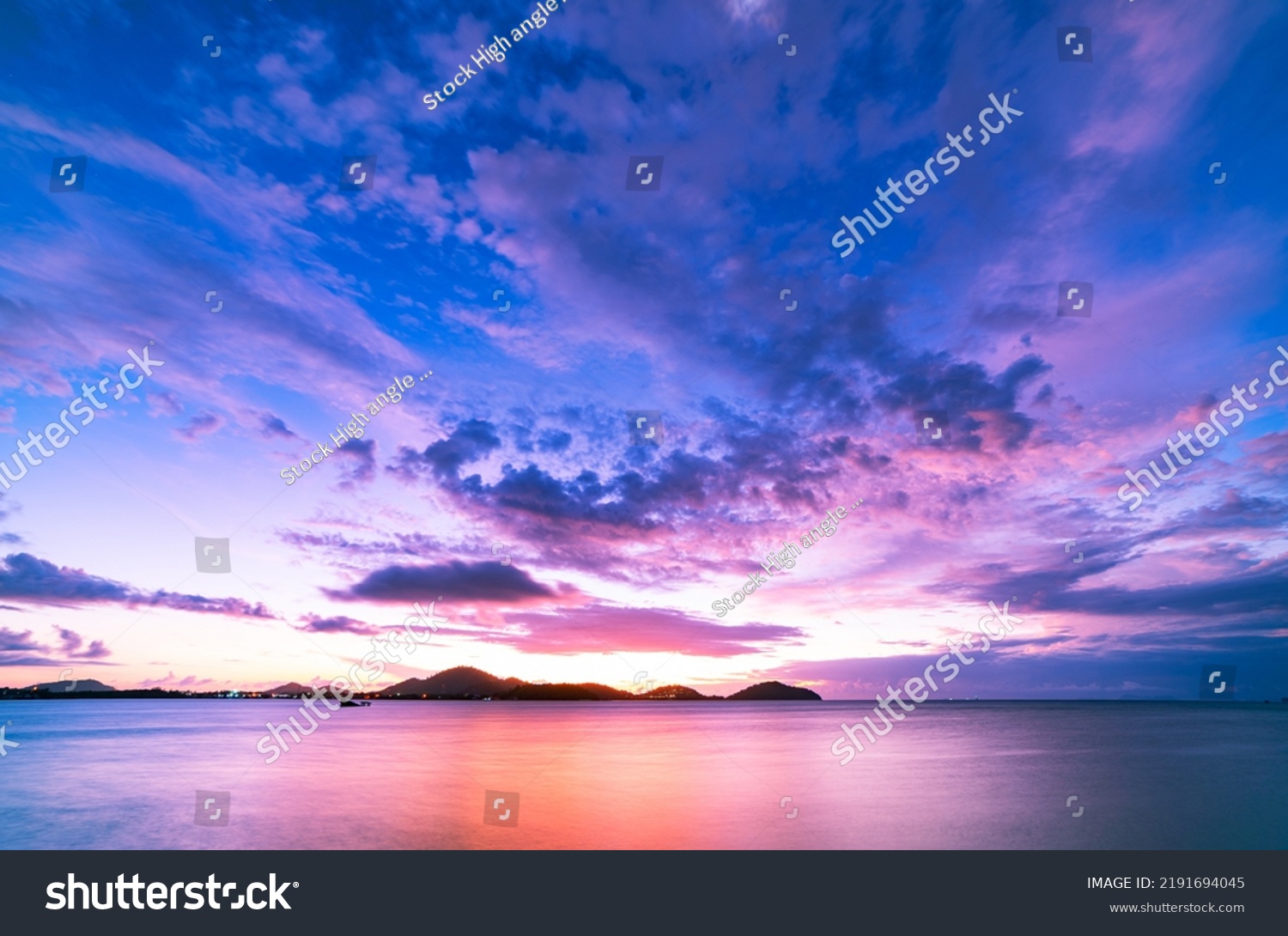 Landscape Long exposure of majestic clouds in the sky sunset or sunrise over sea with reflection in the tropical sea.Beautiful cloudscape scenery.Amazing light of nature Landscape nature background #2191694045