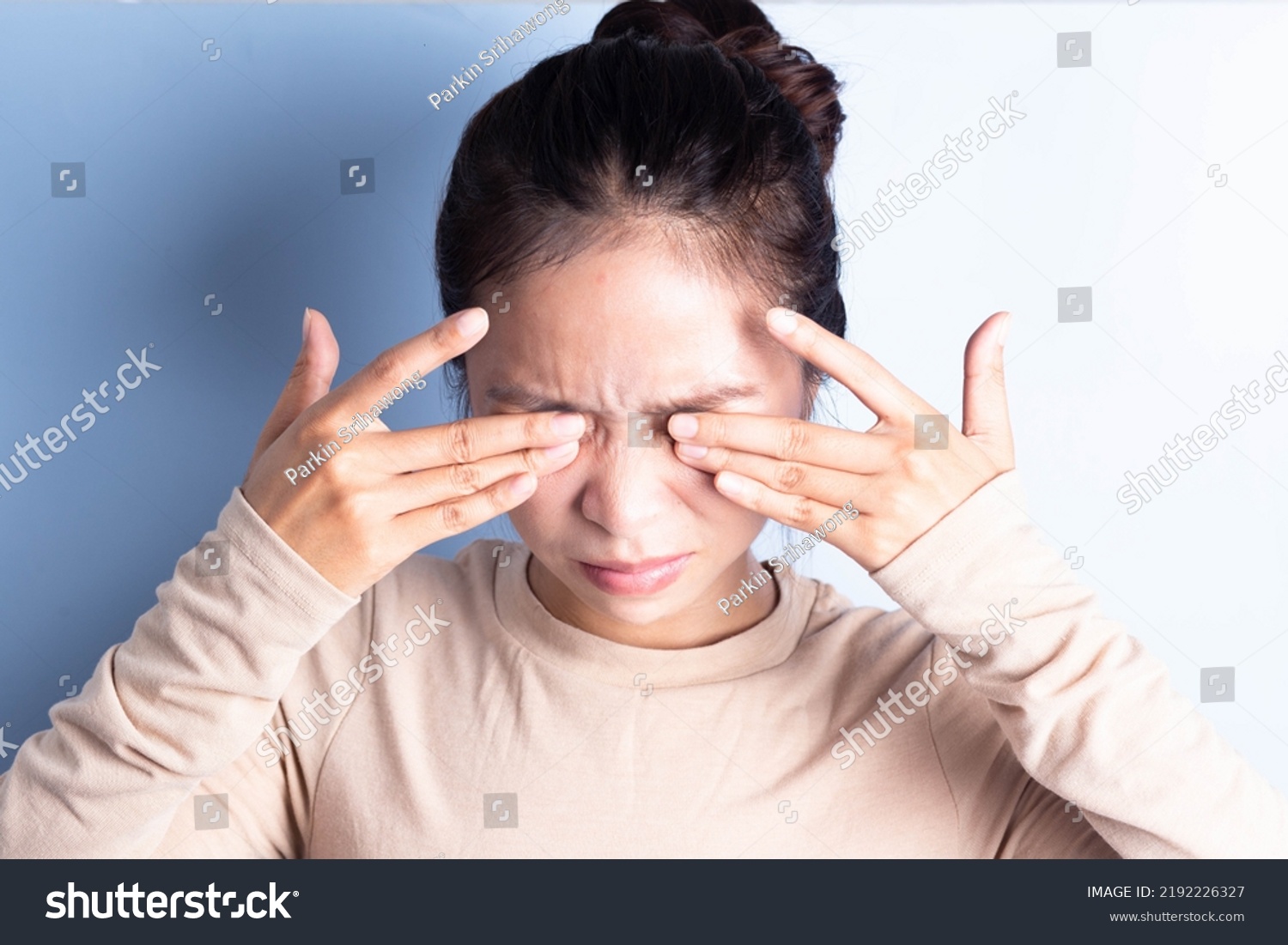 Close-up of young woman rubbing irritated eyes, eye irritation, eye rubbing, eye problems, migraine pain #2192226327