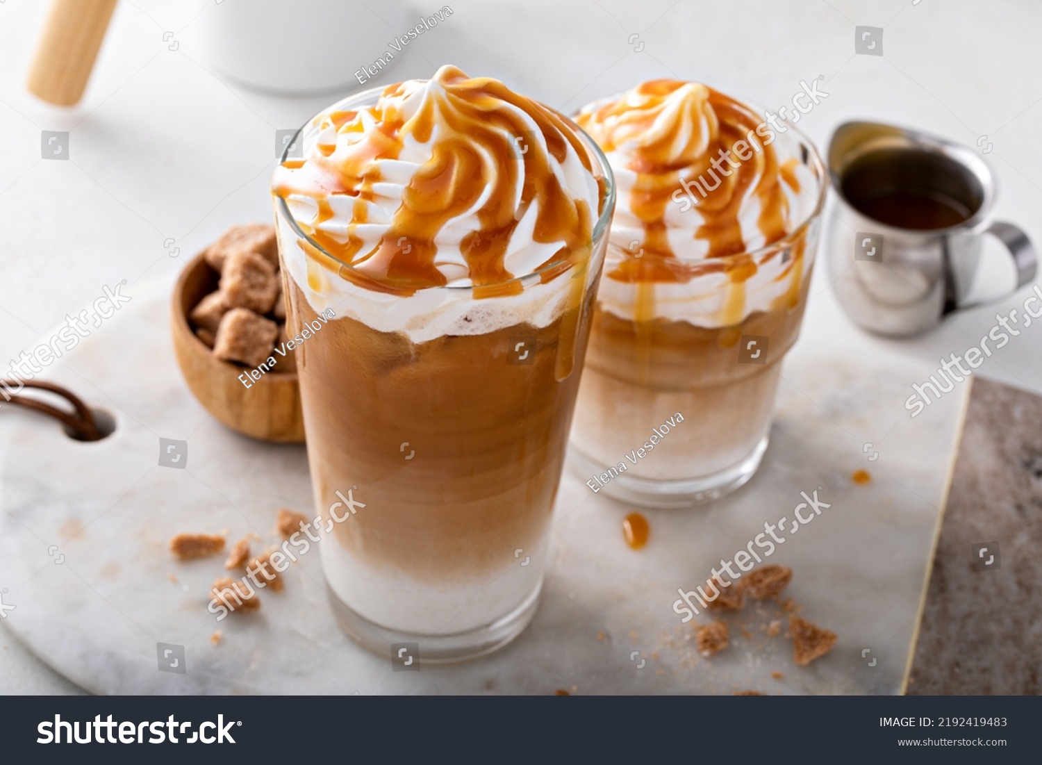 Iced caramel latte topped with whipped cream and caramel sauce, refreshing and sweet coffee drink #2192419483