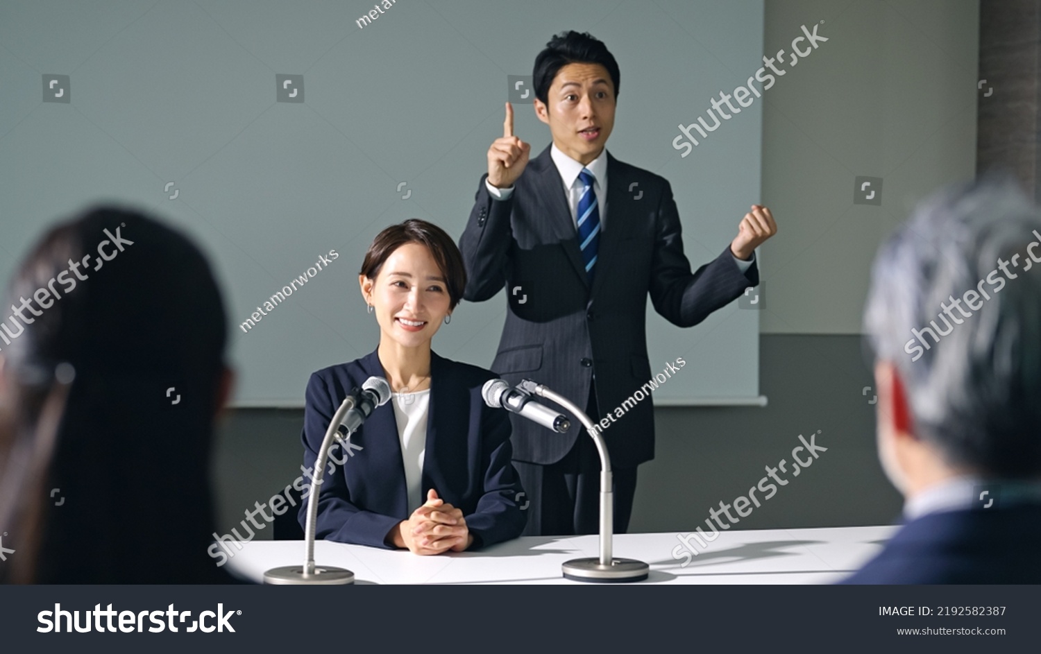 Asian woman and sign language interpreter at press conference. #2192582387