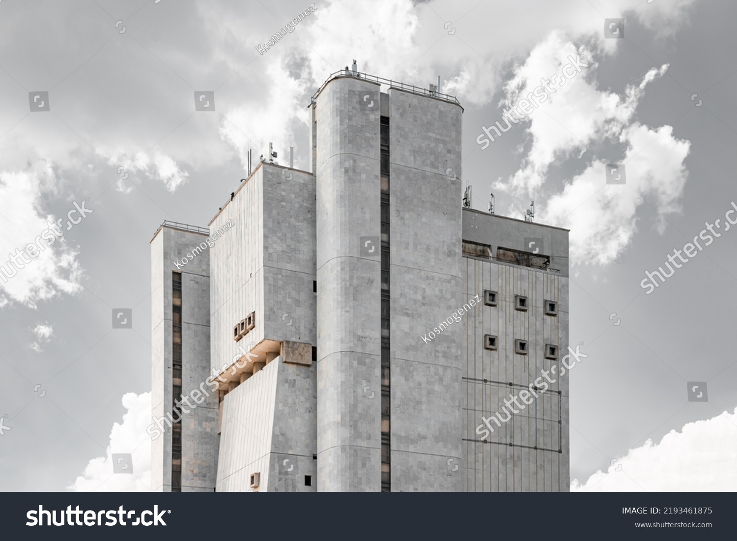 Soviet Brutalist Architecture. High gray walls with small windows. Old Soviet building #2193461875
