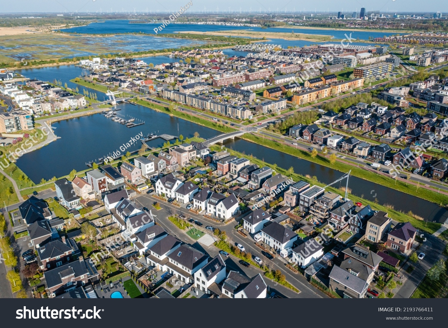 Modern green neighbourhood in Almere, The Netherlands, surrounded by water and nature, city built on reclaimed land (Flevoland polder). Aerial view. #2193766411