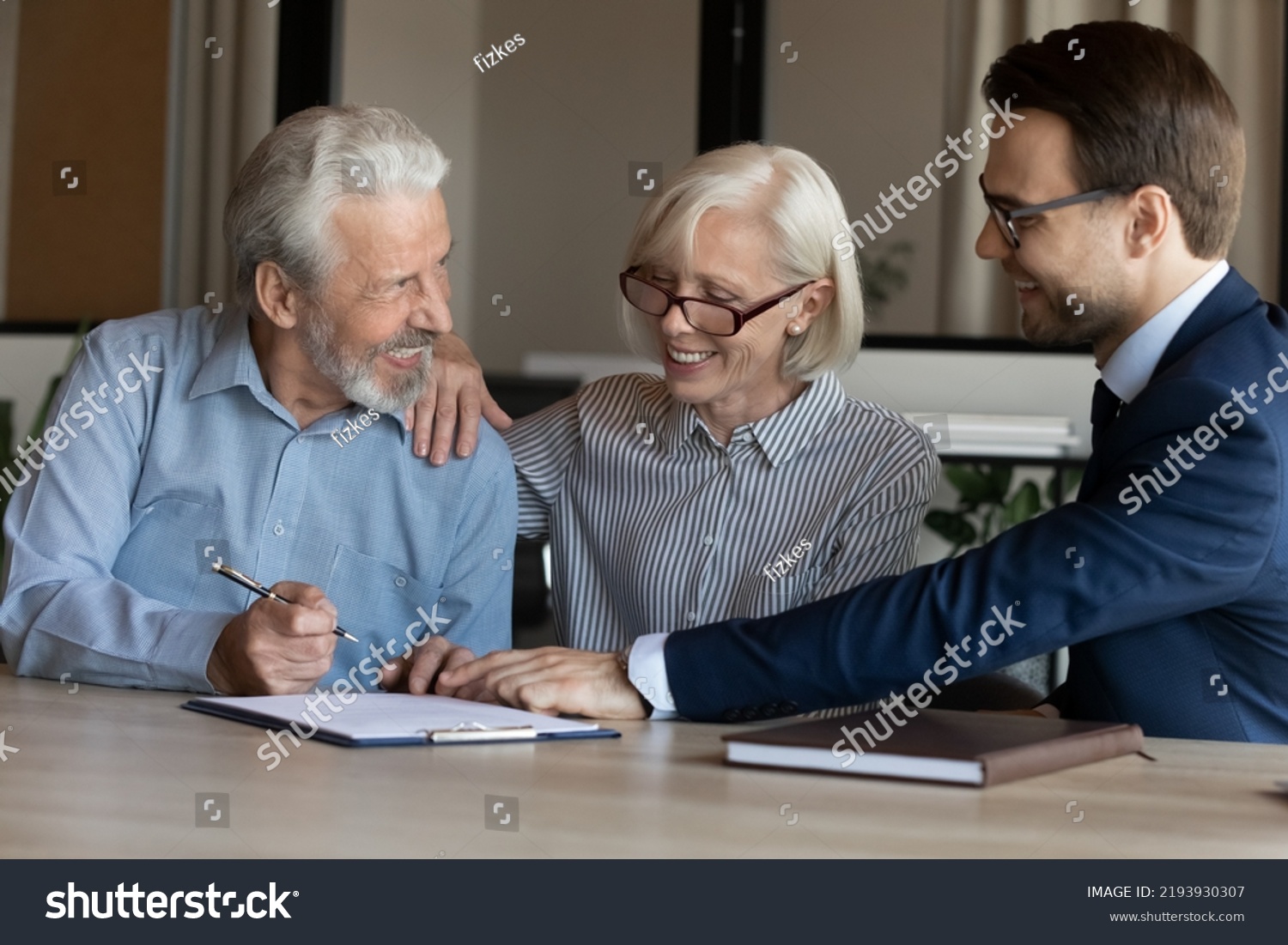 Excited mature couple signing contract with businessman manager realtor broker, making great investment or insurance deal at meeting, happy senior family purchasing real estate, taking loan #2193930307