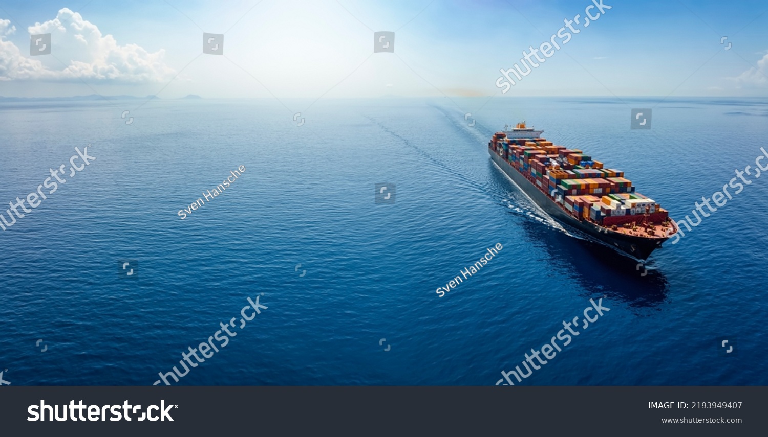 Aerial panorama of a cargo ship carrying container for import and export, business logistic and transportation in open sea with copy space  #2193949407