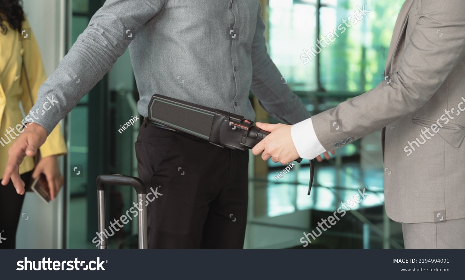 Security officer using a metal detector on a male passenger at airport boarding gate #2194994091