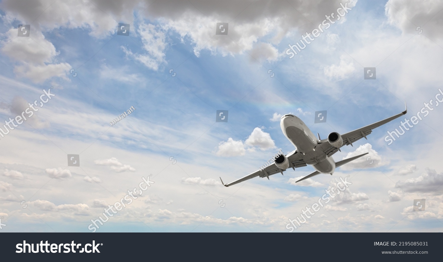 White passenger airplane flying in the sky amazing clouds in the background - Travel by air transport #2195085031