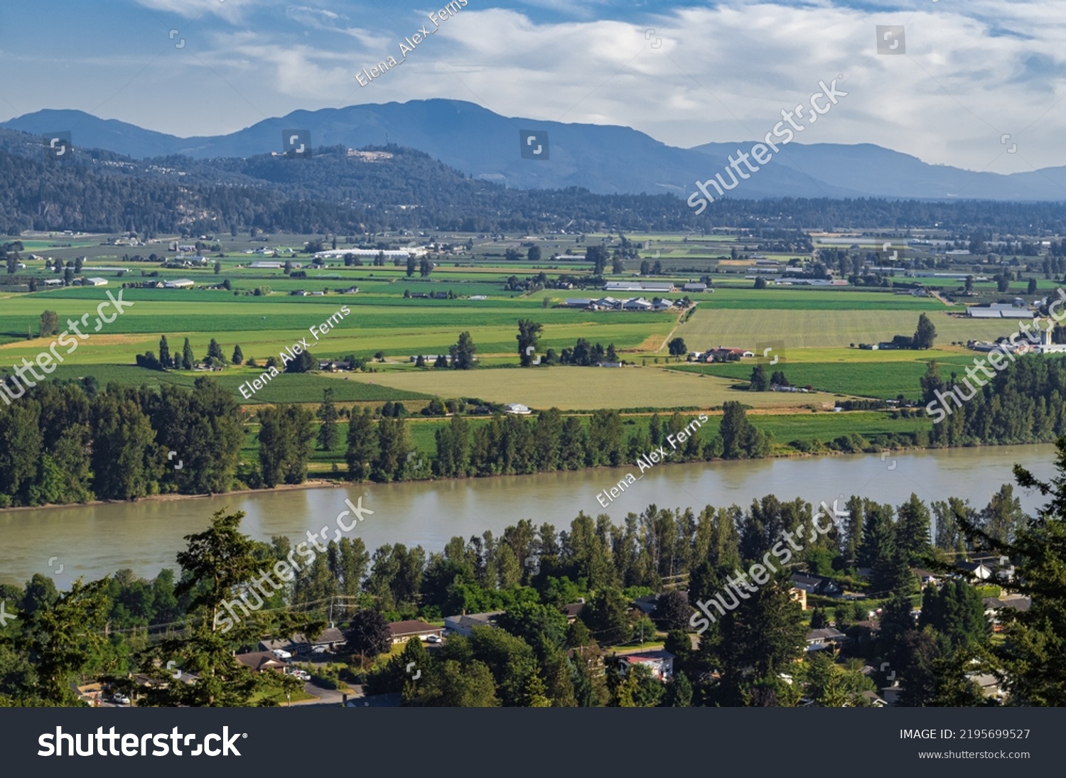 View of the Fraser Valley near Abbotsford BC. Summer in the Fraser Valley. Canadian homestead. Rural agricultural land. The Frazier River is an important salmon habitat for the lower mainland of BC #2195699527