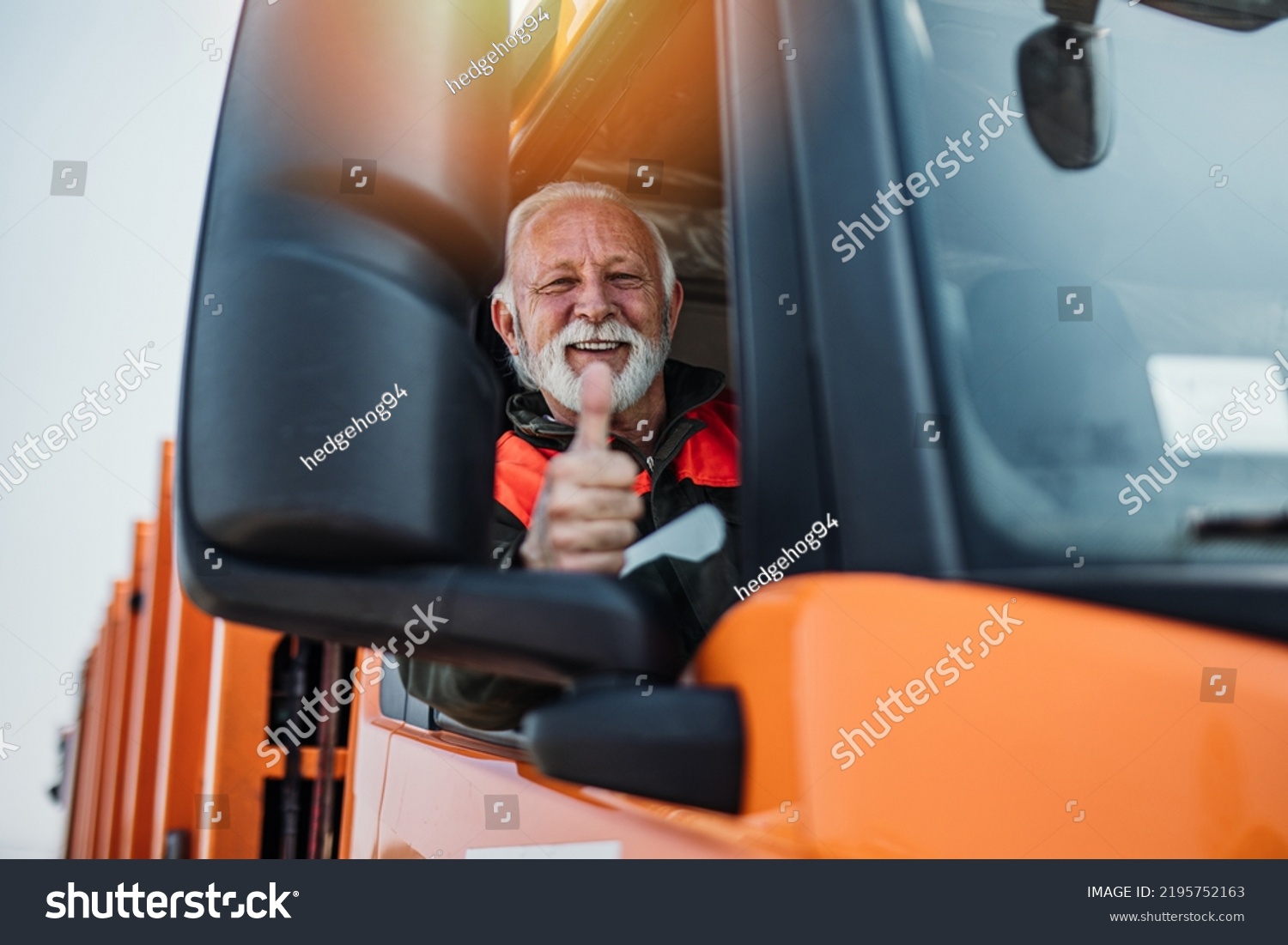 Senior garbage removal worker driving a waste truck. He is showing thumb up. #2195752163
