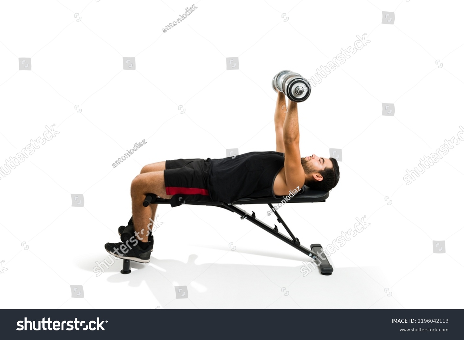 Fitness hispanic man lifting dumbbell weights and exercising doing a bench press isolated on a white background #2196042113
