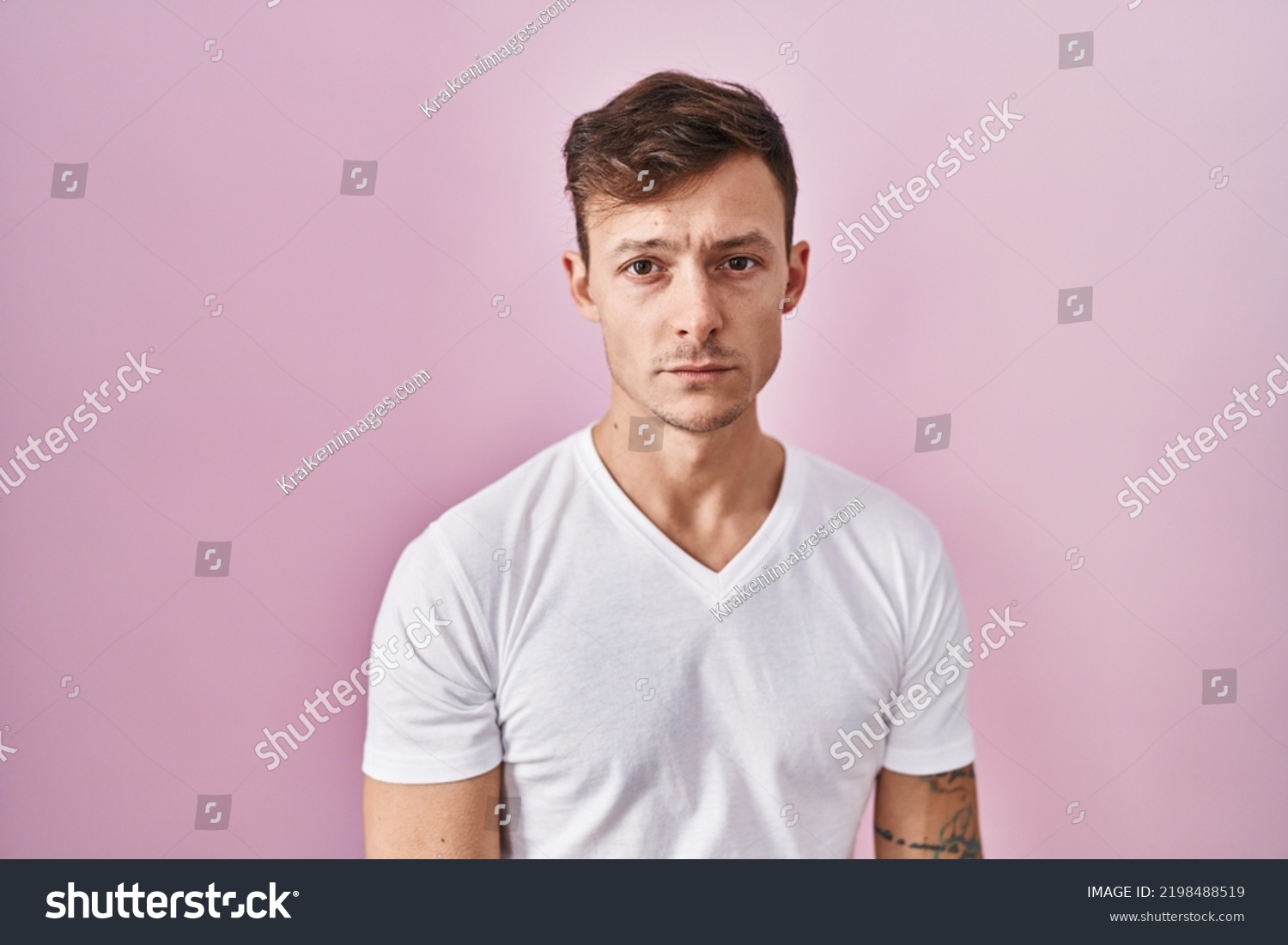 Caucasian man standing over pink background depressed and worry for distress, crying angry and afraid. sad expression.  #2198488519