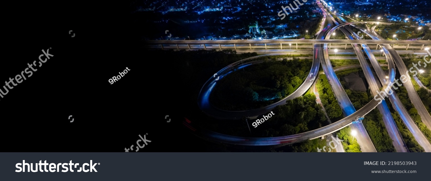 Aerial view of road interchange or highway intersection of Expressway top view, Road traffic an important infrastructure, car traffic transportation above intersection road in city night. #2198503943