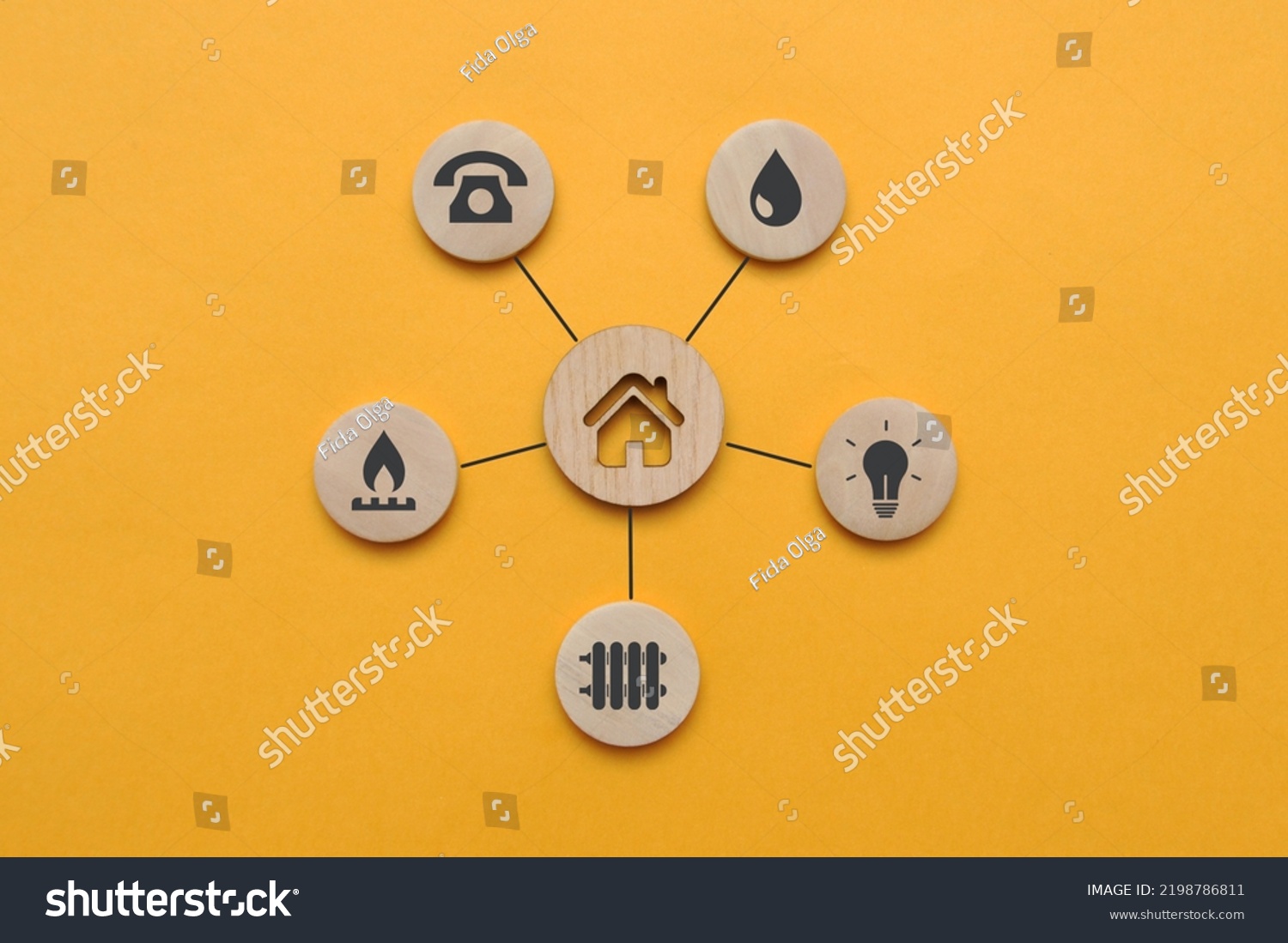 Utility icons on wooden mugs and a house nearby. A symbol of the necessary services in the house #2198786811
